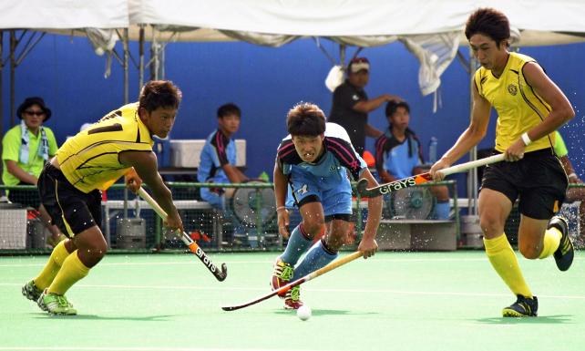 ホッケー男子 懸命にボールを追う置賜農の選手(中央) ©読売新聞社