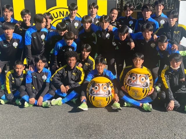 選手権制覇・前橋育英 目入れしたダルマと共に満面の笑みを浮かべる